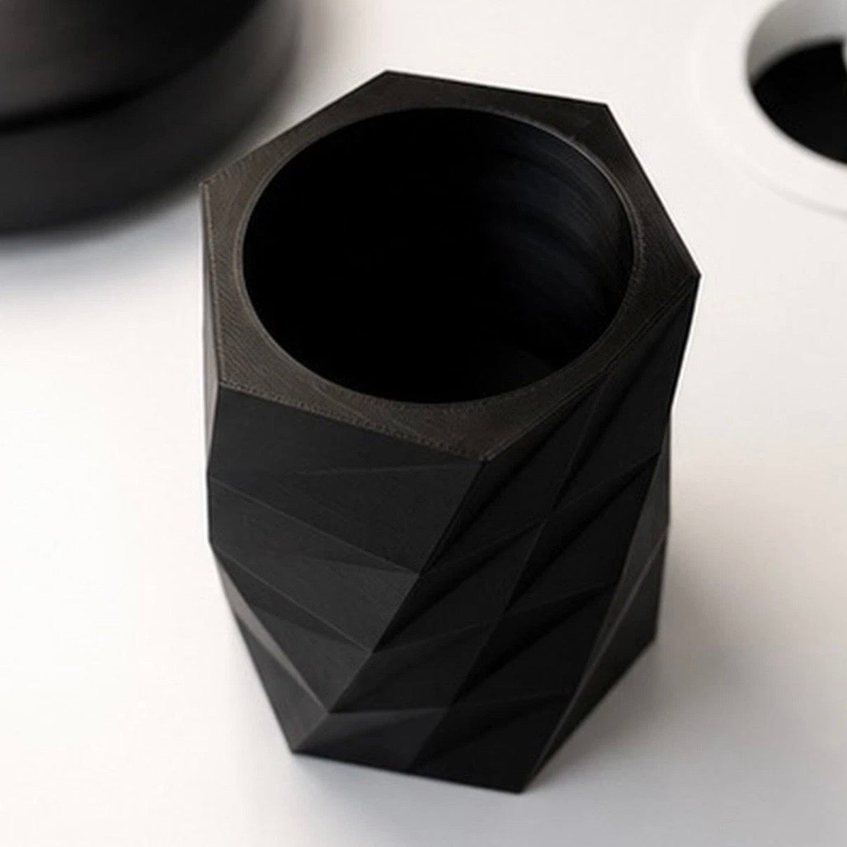 Black geometric vase on a white background