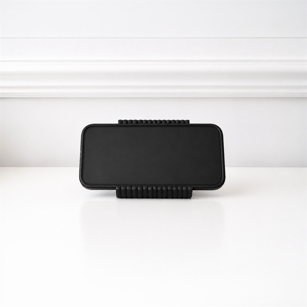 Black rectangular object with textured edges on a white background